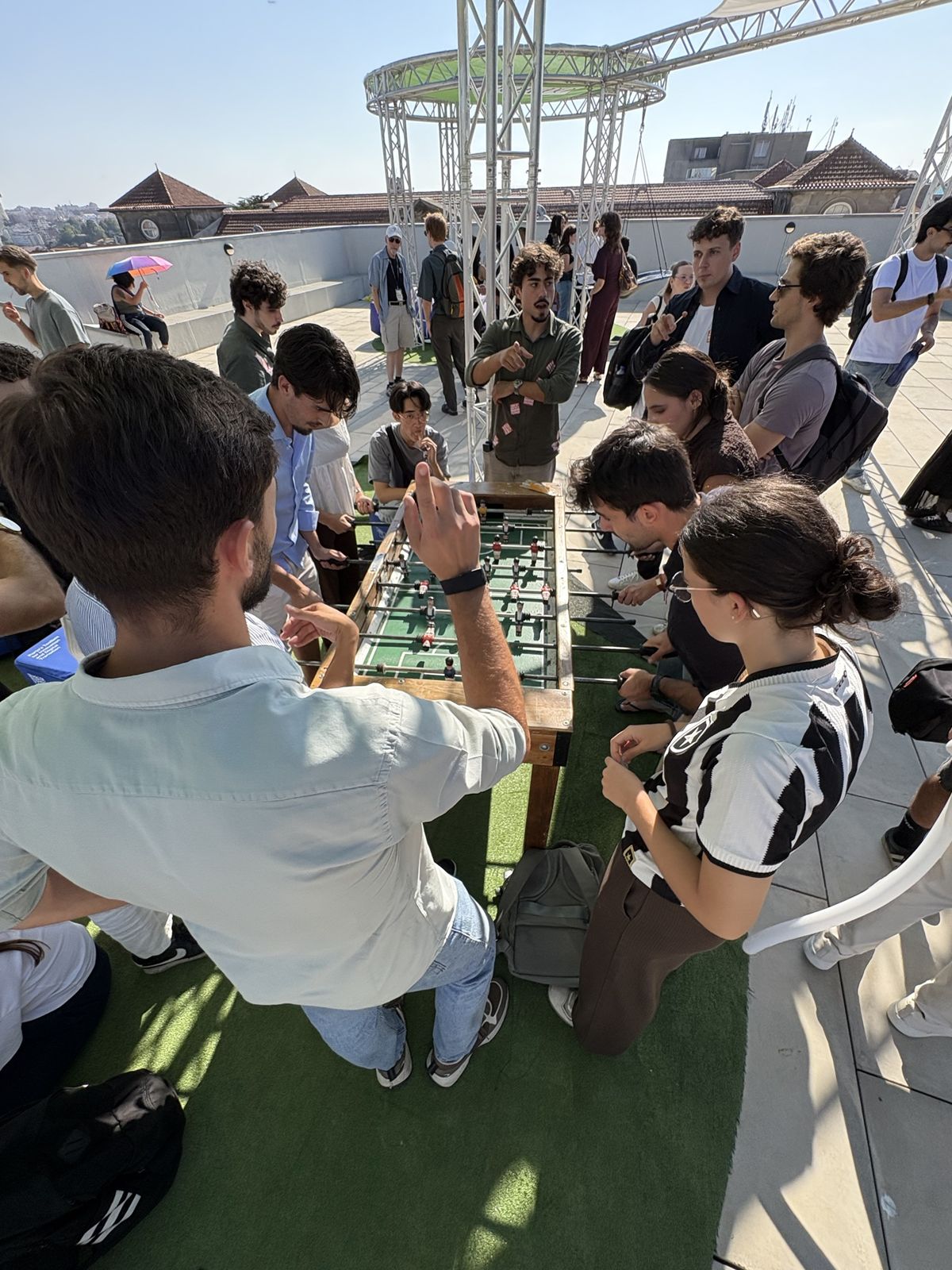 Students from many countries playing table football on a rooftop in Porto
